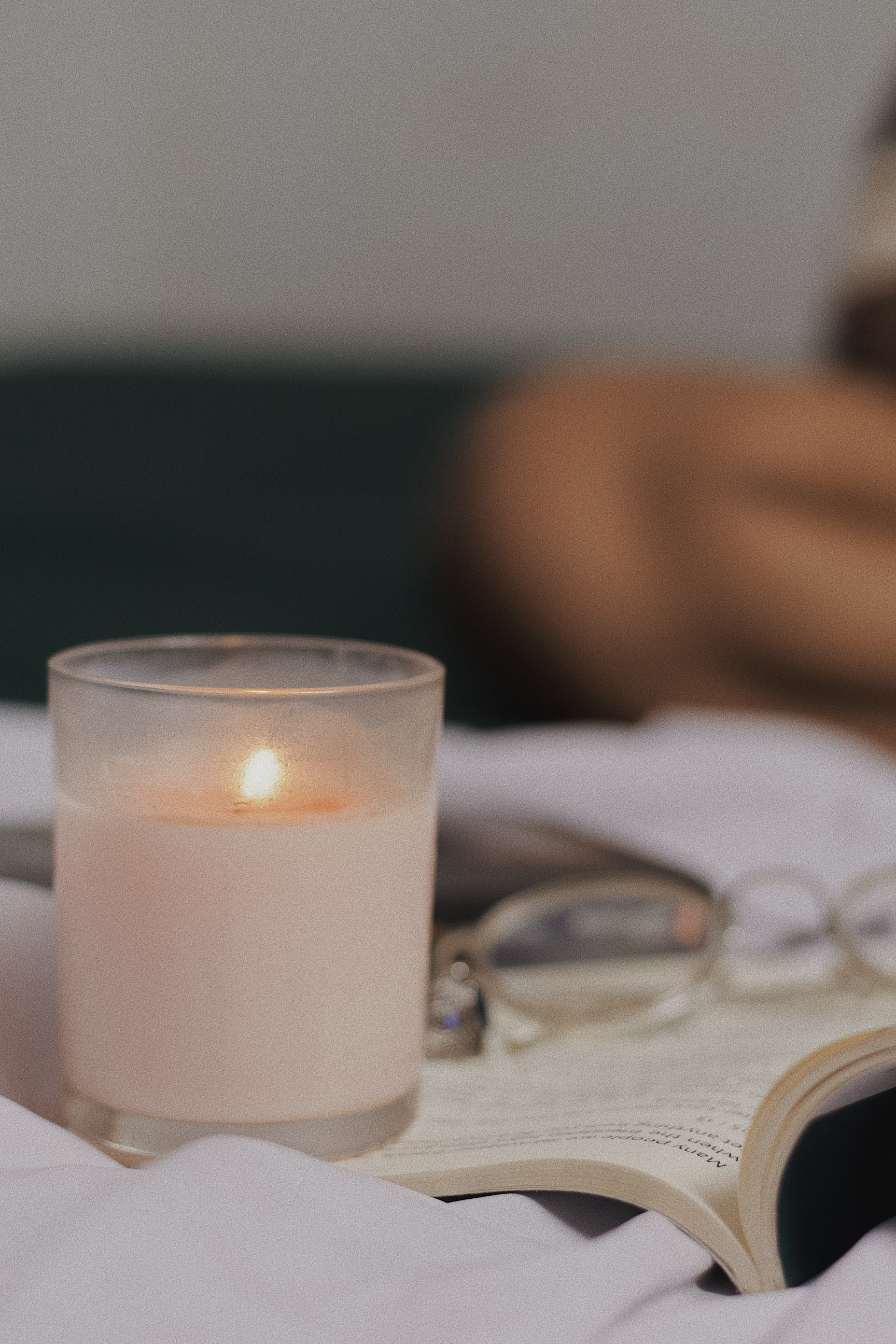 A Lighted Candle in a Glass Container